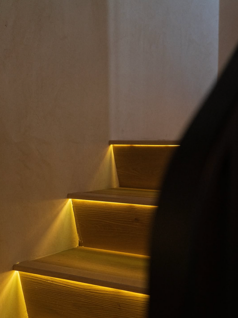 The stairs, lit under each step